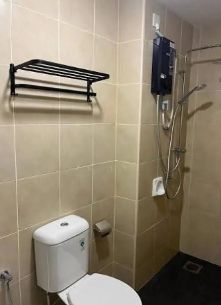 Bathroom features: cream tiled walls, black towel rack, white toilet, shower with handheld showerhead, wall-mounted shower control, grey floor tiles, toilet paper holder, soap dish; style: modern.