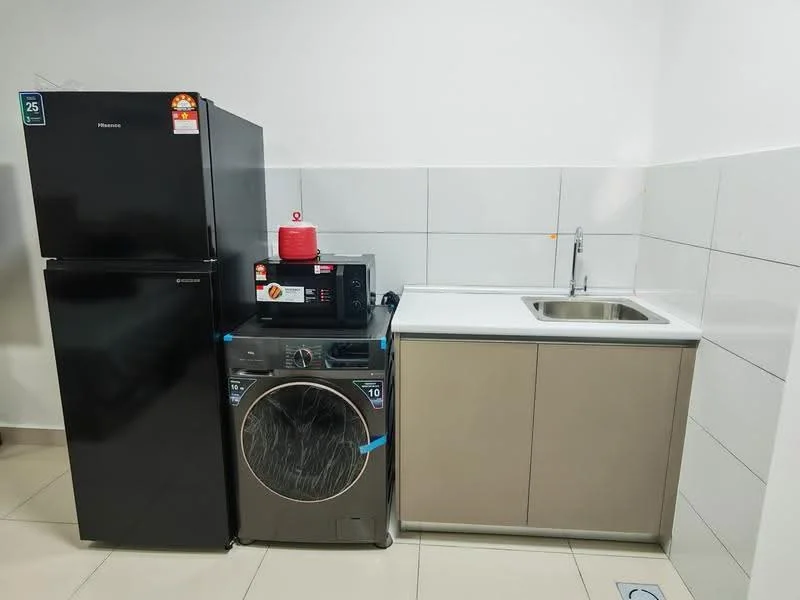 Room features: black fridge, front-load washing machine, microwave, single-bowl stainless-steel sink, grey cabinetry, white countertop, white tiled walls, cream tiled flooring; style: modern.