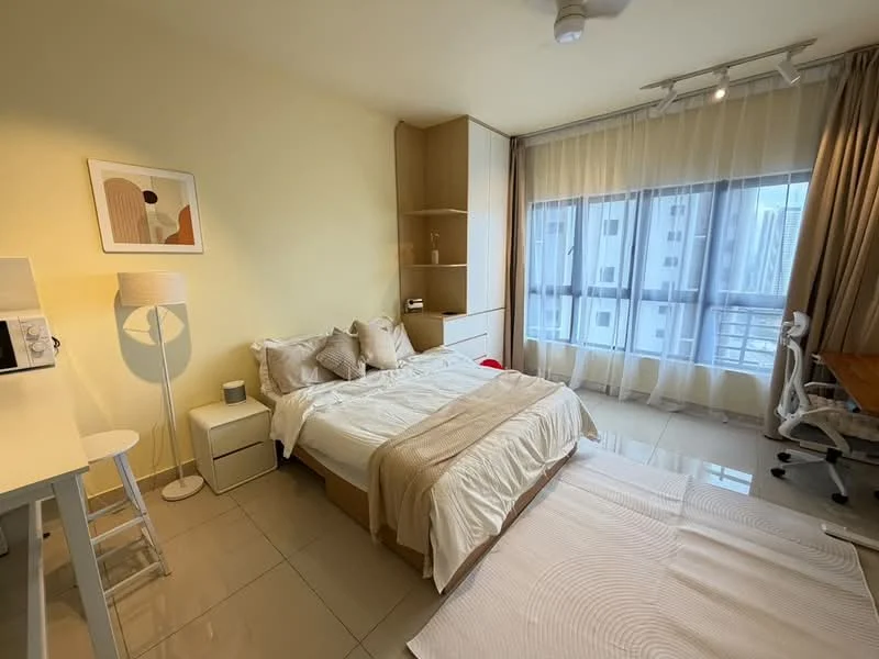 Bedroom features: queen-size bed with beige bedding, upholstered headboard, white bedside table, white floor lamp, built-in wardrobe with wood finish, study desk with chair, floor-to-ceiling windows, sheer curtains, cream painted walls, tile flooring, ceiling fan, decorative artwork on wall; style: modern; view: city.