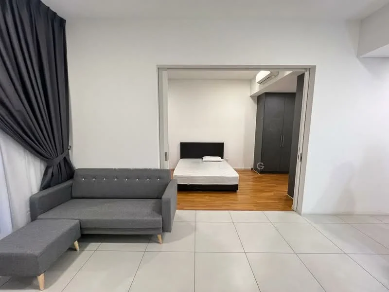 Living features: grey fabric sofa with chaise, white painted walls, tile flooring, curtains in dark grey, wooden flooring visible in adjacent room, doorway leading to bedroom, decorative wall paneling, natural light from window; style: modern. Bedroom features: queen-size bed frame without mattress, wooden flooring, built-in wardrobe, white painted walls, natural light from window; style: modern.