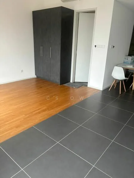 Room features: laminate flooring in light wood finish, ceramic tile flooring in dark grey, built-in wardrobe with grey finish, white walls, doorway leading to another room, small mat at entrance, dining table with chairs visible in background; style: modern.