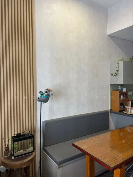 Dining features: wooden dining table, grey upholstered bench seating, textured wallpaper, wood panel accent wall, potted plant, decorative items on table, open shelving with kitchen items, light fixture on wall; style: modern.