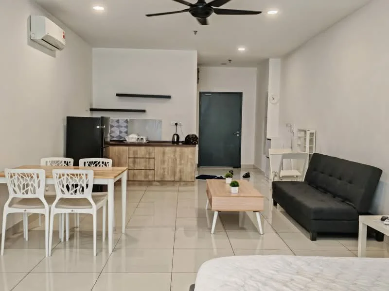 Living features: grey fabric sofa, coffee table, dining table with 4 white chairs, black fridge, kitchen cabinetry in light wood, white countertop, kettle, toaster, wall-mounted split AC, recessed ceiling lights, floor tiles in cream, dark door, decorative plant on table; style: modern.