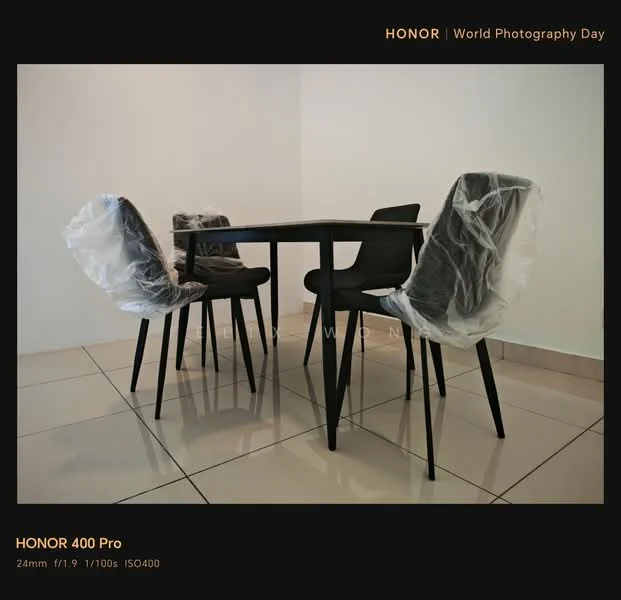 Room features: square dining table, four dining chairs with plastic covers, glossy tiled flooring, plain white walls, neutral color scheme; style: modern.