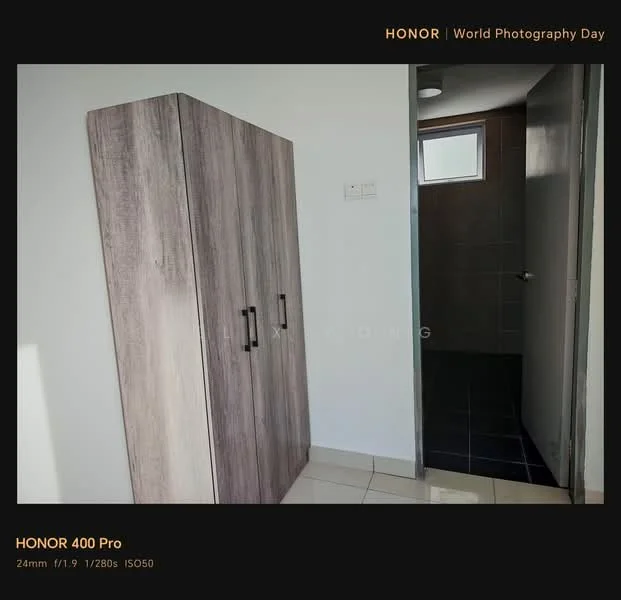 Room features: light grey walls, white ceiling, tile flooring, wooden wardrobe with two doors, doorway leading to bathroom, dark tiled flooring in bathroom, overhead light fixture; style: modern.