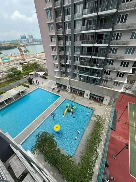 Exterior type: high-rise condominium; features: infinity pool, pool deck with loungers, children's water slide, landscaped garden area, tennis court, surrounding construction site, view of nearby water body, multiple balconies on building facade; style: modern.