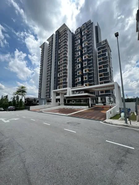 Exterior type: high-rise condominium; features: modern facade with glass and concrete, multiple recessed balconies, main entrance with covered drop-off area, landscaped entrance with palm trees, paved driveway, surrounded by greenery, visible parking area, approximately 10-storey high-rise; style: modern.