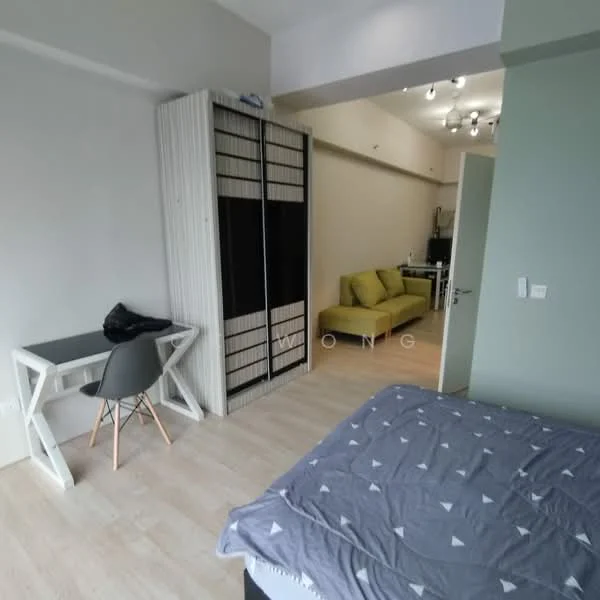 Room features: light wood flooring, white painted walls, grey bedding with geometric pattern, black bed frame, built-in wardrobe with sliding doors, small study desk, grey chair, sofa in green, recessed ceiling lights; style: modern.