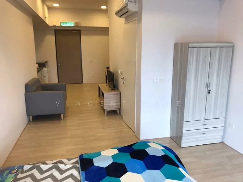 Room features: laminate flooring, white painted walls, air conditioning unit, sofa in grey, TV console, wall-mounted TV, wooden wardrobe, bed with patterned blanket, light-colored cabinetry, open layout, natural light from window; style: modern.