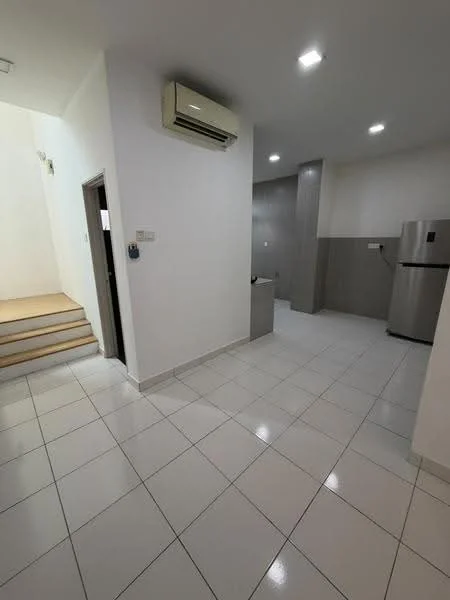 Kitchen features: white painted walls, grey tiled backsplash, ceramic tile flooring, stainless-steel fridge, 1 wall-mounted split AC, recessed LED downlights, single-bowl stainless-steel sink, chrome pull-down faucet, grey cabinetry, countertop with grey finish; style: modern. Room features: white painted walls, ceramic tile flooring, staircase leading up, doorway to another room.