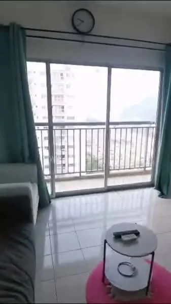 Living features: floor-to-ceiling sliding glass door, curtains in light blue, white walls, grey sofa, round coffee table with pink mat, clock on the wall, tile flooring, city view through the balcony; style: modern; view: city.