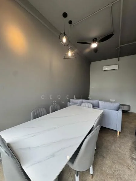 Dining features: marble dining table, 6 upholstered dining chairs in grey, 3-blade ceiling fan, pendant lighting with geometric design, grey painted walls, exposed ceiling pipes, wall-mounted split AC, concrete flooring; style: modern.