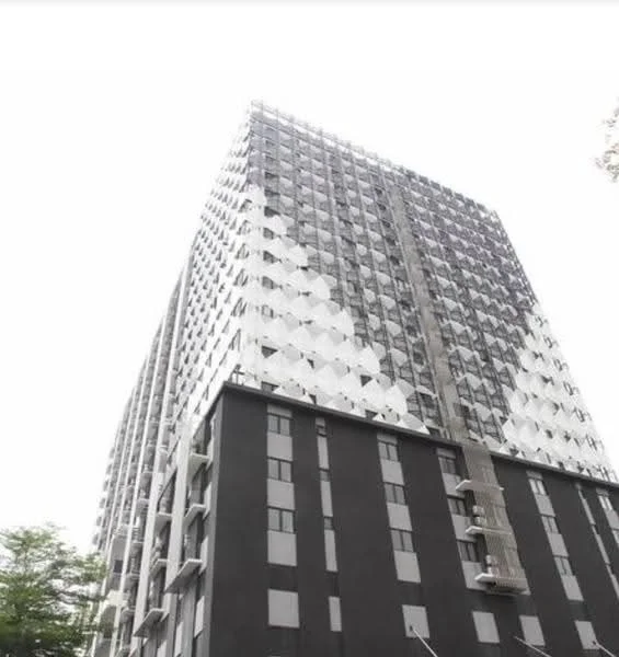 Exterior type: high-rise condominium; features: glass curtain wall, black painted facade, white geometric pattern on upper floors, balconies on upper levels, multiple air conditioning units visible, approximately 20-storey high-rise; style: modern.