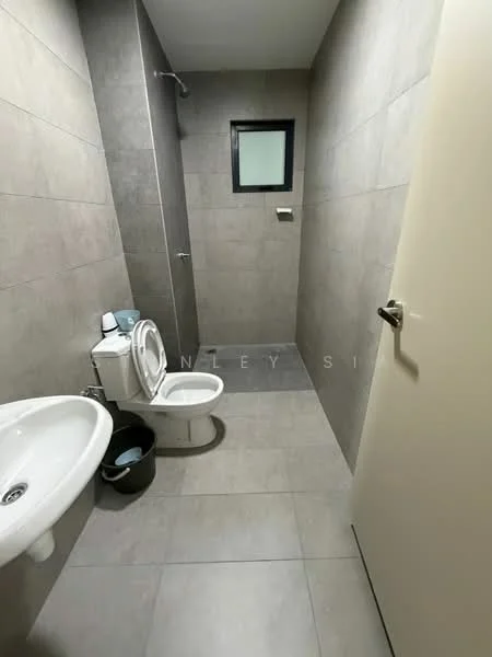 Bathroom features: grey tiled walls, grey tiled flooring, white wall-mounted sink, chrome basin mixer faucet, one-piece toilet, walk-in shower with glass partition, small window, toilet paper holder, bucket, shower head; style: modern.