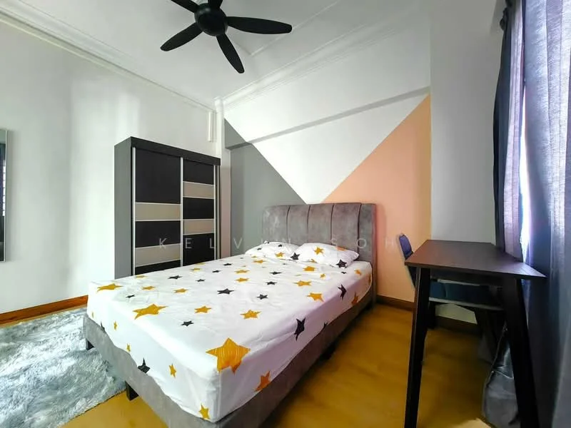 Bedroom features: queen-size bed with star-patterned bedding, upholstered headboard, wooden flooring, grey fabric wardrobe with sliding doors, study desk, ceiling fan, curtains, decorative area rug; style: modern.