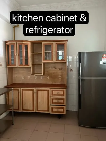 Kitchen features: wooden kitchen cabinets with glass-front upper cabinets, three lower drawers, stainless-steel refrigerator, countertop surface, white tiled backsplash, cream tiled walls, brown tiled flooring, exposed pipes, open shelving; style: traditional.