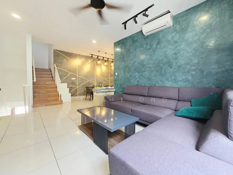 Living features: L-shape sectional sofa in grey, coffee table with black metal base, green decorative cushion, wall-mounted air conditioning unit, recessed LED downlights, feature wall with green textured finish, white painted walls, large floor tiles, wooden staircase in background, dining area visible in background; style: modern.