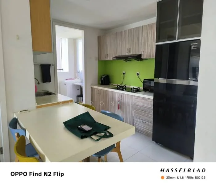 Kitchen features: green accent wall, light wood cabinetry, black refrigerator, built-in stove, white countertop, white tile flooring, dining table with four chairs, sink, wall-mounted kitchen hood, window with natural light; style: modern.