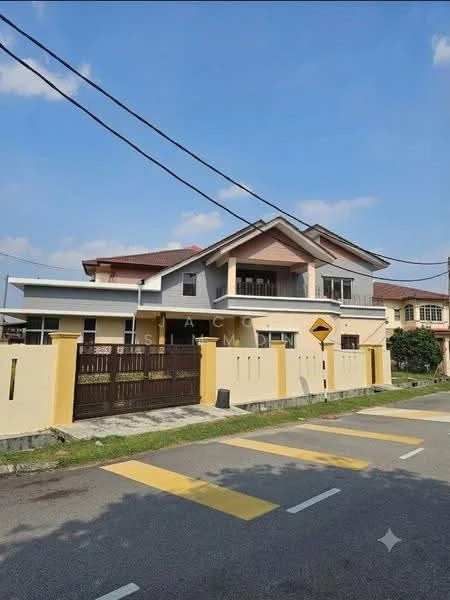Exterior type: detached bungalow; features: cream painted facade, pitched tile roof, double-storey, manicured lawn, paved driveway, front gate with intercom, balcony on upper floor, surrounded by mature greenery; style: modern.