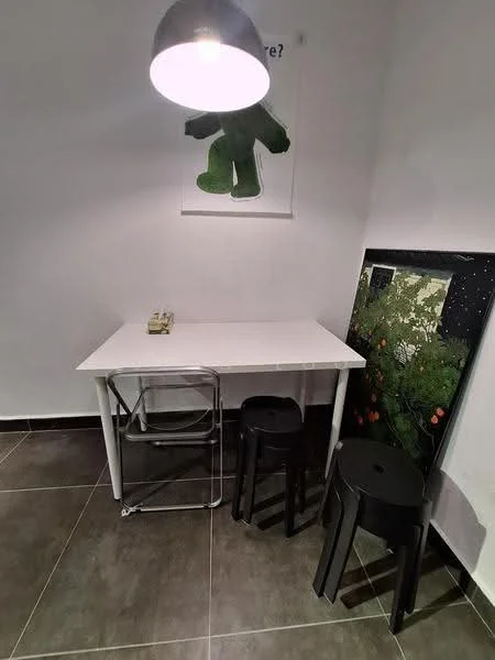 Room features: white table, metal folding chair, two black stools, pendant light, grey tiled flooring, white painted walls, framed artwork on wall, decorative poster on wall; style: modern.