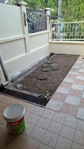 Room features: tiled flooring in beige and cream, exposed soil area, decorative stones, white painted walls, fenced area, drainage system visible, outdoor space, greenery visible in background; view: garden.