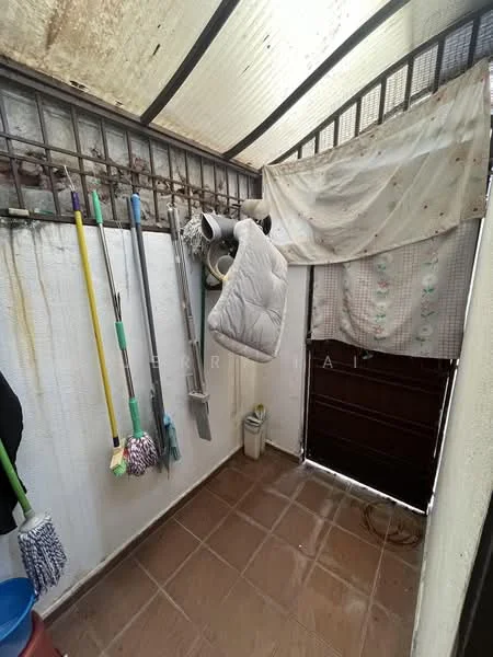 Laundry features: tile flooring, white painted walls, metal window grills, hanging mop, hanging broom, hanging cleaning supplies, hanging quilt, door leading outside.