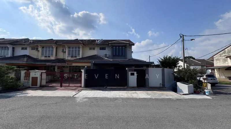 Exterior type: linked terrace house; features: two-storey building, white painted facade, black gate, paved driveway, manicured lawn, front porch, balconies on upper floor, surrounded by residential area, visible street, electricity poles, clear blue sky; style: modern.