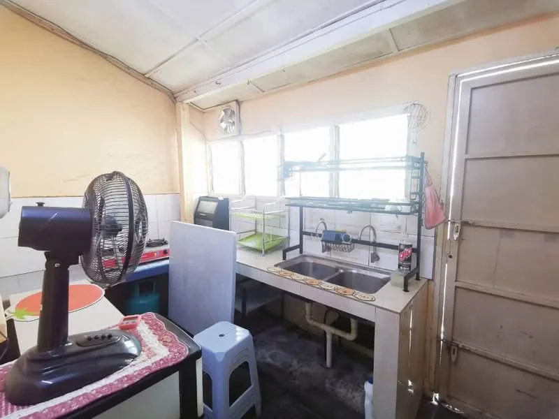 Kitchen features: single-bowl stainless-steel sink, chrome pull-down faucet, white laminate countertop, wall-mounted fan, stainless-steel gas stove, open shelving, white tiled walls, grey flooring, window with multiple panes, door leading outside.