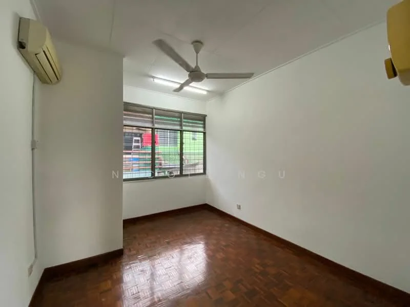 Room features: white painted walls, wooden flooring, 1 wall-mounted split AC, 5-blade ceiling fan, large window with metal grille, natural light, corner room, no visible furniture; style: minimalist.