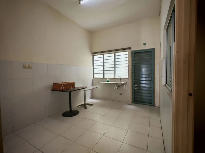 Room features: white tiled walls, white tiled flooring, single window with horizontal slats, green door, table with black surface, sink with faucet, light fixture on ceiling.