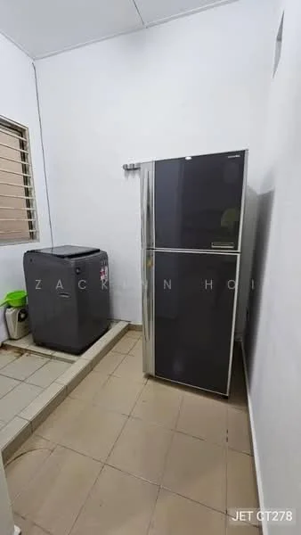 Laundry features: grey double-door fridge, front-load washing machine, tile flooring, white painted walls, window with horizontal bars, countertop space, green trash bin.