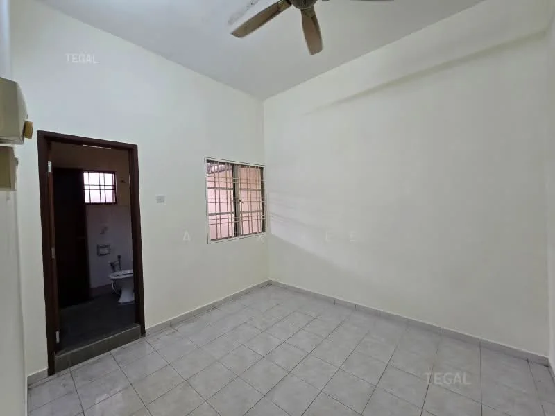 Room features: white painted walls, tile flooring, ceiling fan, window with metal grille, door leading to bathroom, light switch, corner of room with no visible furniture.