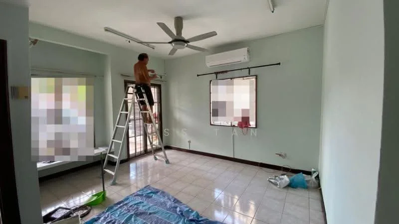 Room features: light green painted walls, white ceiling, ceiling fan, wall-mounted air conditioning unit, tiled flooring, large window with black frame, sliding door, ladder, blue tarp on floor, paint supplies, open space layout.