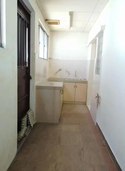 Kitchen features: single-bowl stainless-steel sink, wood cabinetry, countertop with tile backsplash, wall-mounted faucet, window for natural light, door leading outside, tile flooring, light fixture on ceiling.