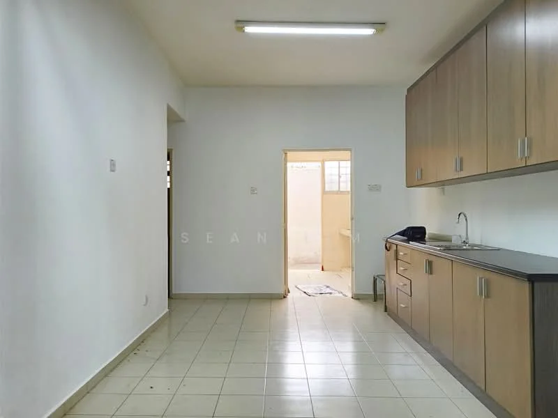 Kitchen features: white painted walls, light tile flooring, wood cabinetry, black countertop, single-bowl stainless-steel sink, chrome pull-down faucet, fluorescent ceiling light, open layout, doorway leading to another room.