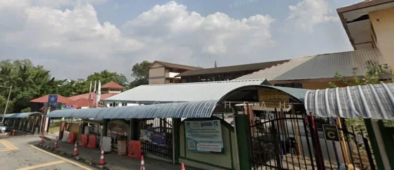 Exterior features: metal roofing, covered walkway, gated entry, surrounded by greenery, multiple building structures, paved road, traffic cones, signage visible; style: modern.
