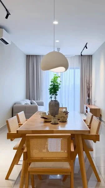Dining features: wooden dining table, 4 wooden dining chairs with cane backing, decorative vase with greenery, ceramic dinnerware, pendant light fixture, light grey curtains, floor-to-ceiling windows, wall-mounted TV console, sofa in light grey fabric, white painted walls, glossy tile flooring, wall-mounted air conditioning unit; style: modern.
