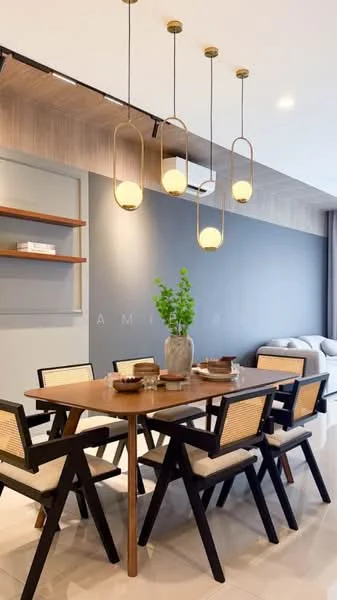 Dining features: 6-seater dining table, wooden dining table with natural finish, black wooden dining chairs with cane backrest, pendant lighting with gold finish, decorative vase with greenery, ceramic plates, cutlery, wall-mounted shelf, grey accent wall, glossy tile flooring; style: modern.