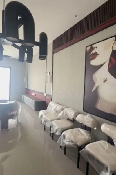 Living features: polished tile flooring, grey painted walls, feature wall with artwork, chandelier with black finish, wall-mounted TV console, seating area with upholstered chairs, large window with natural light, decorative wall paneling; style: modern.