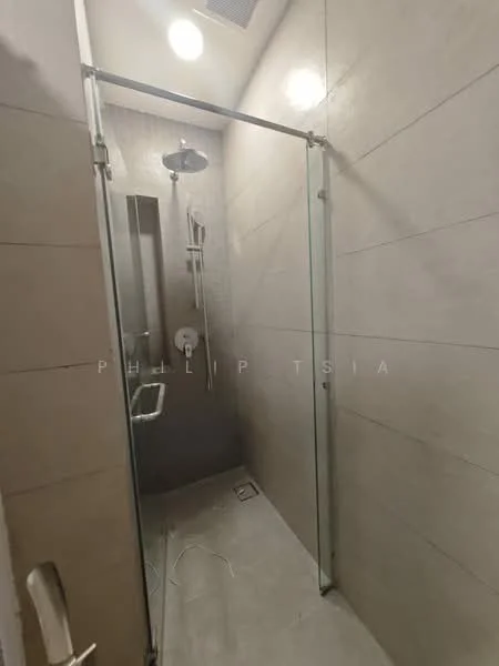 Bathroom features: glass shower enclosure, rain shower head, handheld shower, wall-mounted shower controls, tile cladding on walls, light-colored tile flooring, built-in shower niche, modern faucet, sliding glass door; style: modern.