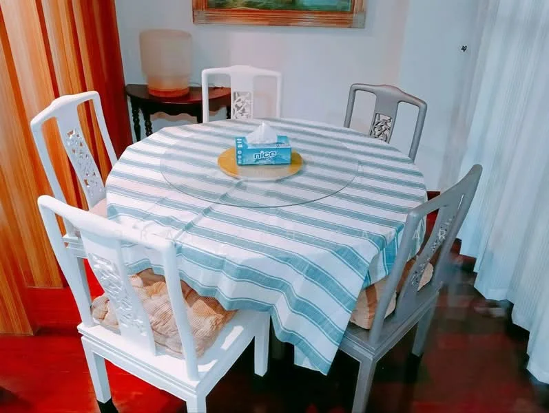 Dining features: round dining table with glass top, striped tablecloth, 4 upholstered dining chairs, wooden flooring, decorative wall art, curtains, ambient lighting, centerpiece plate; style: modern.