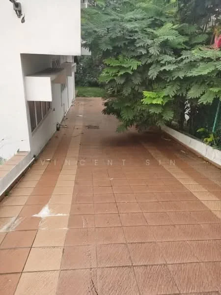 Exterior features: paved walkway, landscaped greenery, surrounded by trees, white walls of building, outdoor space, sloped pathway.