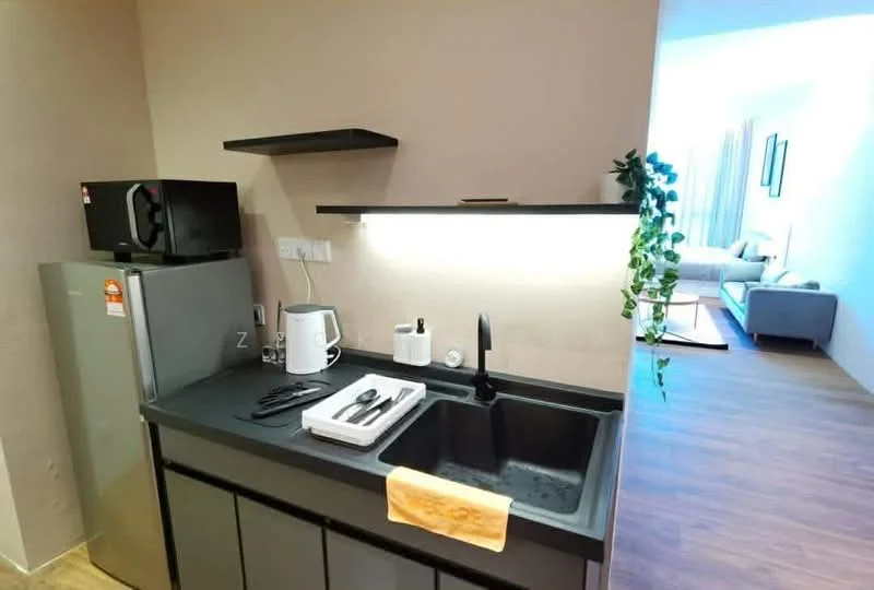 Kitchen features: black countertop, single-bowl stainless-steel sink, chrome pull-down faucet, black cabinetry, microwave, stainless-steel fridge, kettle, cutlery, wall-mounted shelf, LED under-cabinet lighting, greenery decor; style: modern. Room features: light-colored walls, wood flooring, sofa visible in background, natural light from window.