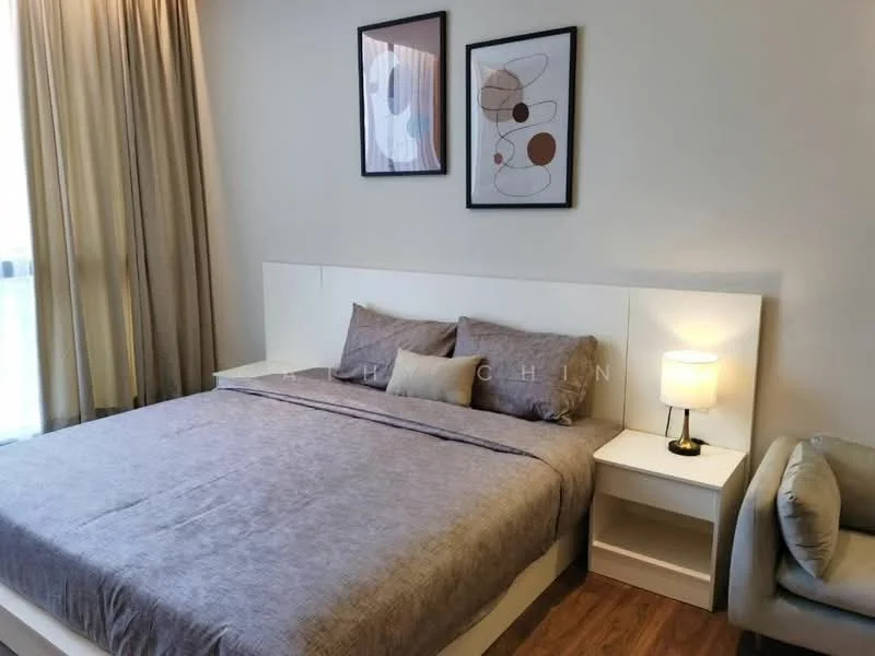 Bedroom features: king-size bed with grey bedding, upholstered headboard, two framed abstract artworks on the wall, nightstand with lamp, curtains covering the window, wooden flooring, decorative armchair, wall-mounted light fixture; style: modern.