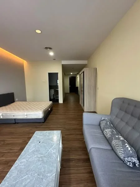 Living features: grey fabric sofa, coffee table with marble top, wooden flooring, recessed ceiling lights, accent wall with lighting, open layout, large window, neutral wall color; style: modern. Room features: unmade bed frame, wooden flooring, neutral wall color, doorway leading to hallway.