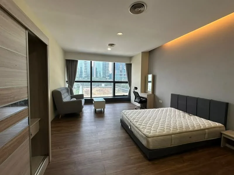 Bedroom features: queen-size bed base without mattress, upholstered headboard in grey, 2 bedside tables, fabric sofa in grey, study desk with chair, large floor-to-ceiling windows, curtains, wooden flooring, recessed ceiling lights, wall-mounted mirror; style: modern; view: city.