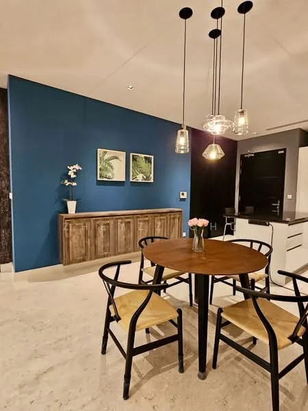 Dining features: round wooden dining table, 4 black wooden chairs with woven seats, pendant lighting with glass shades, blue accent wall, cream marble flooring, wooden sideboard, framed artwork on wall, decorative flower vase with pink flowers; style: modern.