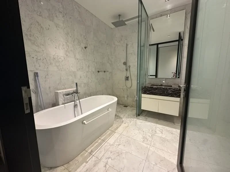 Bathroom features: freestanding bathtub, walk-in shower with glass enclosure, rain shower head, handheld shower, single-sink vanity with white cabinet, marble countertop, mirror with frame, marble tile flooring, grey marble wall cladding, chrome basin mixer, glass shower door, recessed downlights; style: modern.