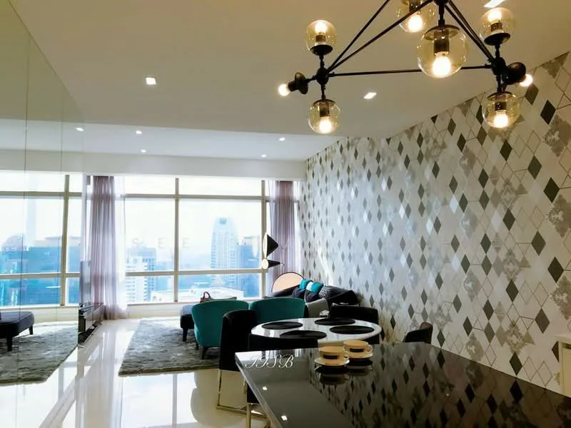 Living features: floor-to-ceiling windows, city view, grey patterned accent wall, white painted walls, polished marble flooring, modern chandelier, 3-seater fabric sofa in teal, black coffee table, area rug with geometric pattern, decorative floor lamp, recessed downlights; style: modern.