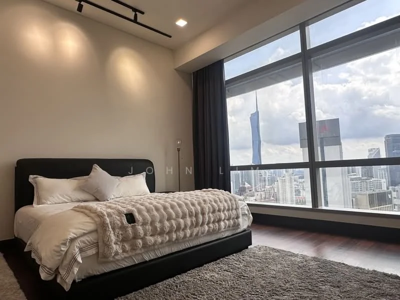 Bedroom features: king-size bed with upholstered headboard, white bedding with decorative throw, dark wood flooring, floor-to-ceiling windows, city skyline view, grey curtains, recessed ceiling lights, wall-mounted reading light, minimalist decor; style: modern; view: city.